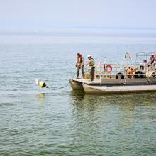 Workers on a boat doing environmental studies