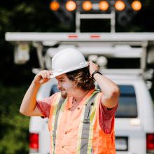 worker in front of a pavement truck