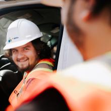 Two workers in a pavement truck