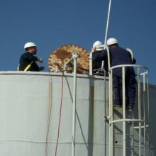 workers inspecting a tank