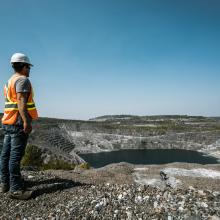 Worker looking a the mine lake