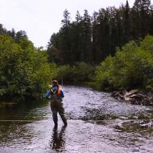 Englobe employee testing river water