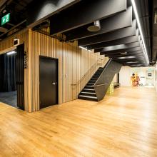 An interior shot of the Roxy Theater featuring a long hallway wood floors and overhead ceiling work