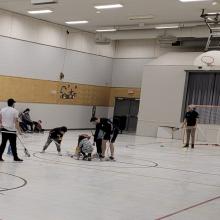 A community gymnasium with youth lacrosse players