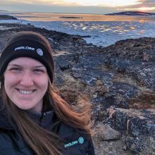 portrait of Lydia Charbonneau with beautiful sunset in background in Nunavik