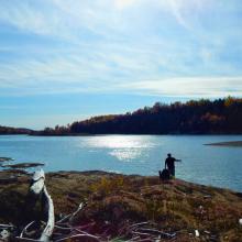 photo of a lake and fisherman in Neqotkuk community