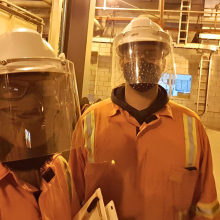 picture of Anthony Allard and collegue on field in their health & safety apparel