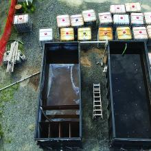 Mobile trailer-mounted seepage and runoff water management system to separate water and oil and to remove volatile organic compounds (VOCs) and hydrocarbons.