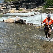 photo of a man in a in-stream spawning ground